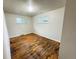 Empty bedroom features hardwood floors and natural light from two windows at 260 Sheridan Blvd, Denver, CO 80226