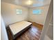 Bedroom featuring hardwood floors, a window, and a bed with a gray frame at 260 Sheridan Blvd, Denver, CO 80226