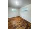 Bright bedroom with hardwood floors, two windows providing natural light, and neutral walls at 260 Sheridan Blvd, Denver, CO 80226