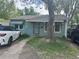 Charming bungalow-style home with a large tree in the front yard at 260 Sheridan Blvd, Denver, CO 80226