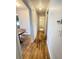 Hallway view leads to the green-tiled bathroom, featuring hardwood floors and neutral walls at 260 Sheridan Blvd, Denver, CO 80226
