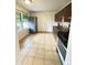 View of kitchen featuring tiled floors, wood cabinets and stainless steel refrigerator at 260 Sheridan Blvd, Denver, CO 80226