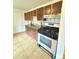 Kitchen with a gas range, tile flooring, and wood cabinets at 260 Sheridan Blvd, Denver, CO 80226