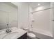 Bright bathroom featuring a tub with shower, a toilet, and a vanity with a light countertop and dark cabinets at 702 N Bently St, Watkins, CO 80137