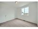 A bright bedroom featuring plush carpet, ample natural light, and a neutral color scheme at 702 N Bently St, Watkins, CO 80137