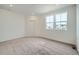 Comfortable bedroom with plush carpeting, natural light, and a calming neutral color palette at 702 N Bently St, Watkins, CO 80137