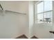 Walk-in closet providing ample storage space and a window for natural light at 702 N Bently St, Watkins, CO 80137