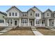 A charming two-story townhome with a welcoming front porch and manicured landscaping at 702 N Bently St, Watkins, CO 80137