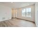 Living room showcasing wood floors, natural light, and a welcoming entryway at 702 N Bently St, Watkins, CO 80137