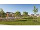 Community park with grassy area, pergola, and nearby homes at 702 N Bently St, Watkins, CO 80137
