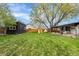 Spacious backyard with a shed, play area with slide, a covered patio and mature tree at 3103 W Bellewood Dr, Englewood, CO 80110