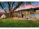 Backyard patio with an outdoor seating area, dining table, string lights, and a hammock at 3103 W Bellewood Dr, Englewood, CO 80110