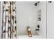 Serene bathroom features a soaking tub with wood tray and sleek black fixtures at 3103 W Bellewood Dr, Englewood, CO 80110