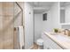 Well-lit bathroom featuring a glass shower with ceramic tile and a sink with modern fixtures at 3103 W Bellewood Dr, Englewood, CO 80110