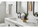 Bathroom features a marble countertop, double sinks, and modern black fixtures at 3103 W Bellewood Dr, Englewood, CO 80110