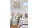 Charming bedroom featuring a cozy bed, stylish nightstand, and decorative wall art at 3103 W Bellewood Dr, Englewood, CO 80110