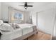 Bright bedroom with natural light, a comfortable bed, and hardwood floors at 3103 W Bellewood Dr, Englewood, CO 80110