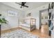Sunlit bedroom showcasing hardwood floors, simple furnishings, and an inviting atmosphere at 3103 W Bellewood Dr, Englewood, CO 80110