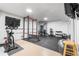 Spacious home gym is equipped with workout machines, weights, and a rubber floor at 3103 W Bellewood Dr, Englewood, CO 80110