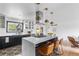 Open kitchen with a large island, pendant lights, and stainless steel appliances with modern features at 3103 W Bellewood Dr, Englewood, CO 80110