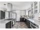 Stylish kitchen featuring patterned tile floors, a spacious island, and modern appliances and fixtures at 3103 W Bellewood Dr, Englewood, CO 80110