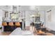 Open-concept kitchen with a large island and stylish seating connects to bright living and dining areas at 3103 W Bellewood Dr, Englewood, CO 80110