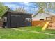 The backyard shed featuring board and batten siding plus a play area with slide at 3103 W Bellewood Dr, Englewood, CO 80110