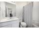 The bathroom features a shower with striped curtain and a white vanity with mirror at 1342 Independence St # 6, Lakewood, CO 80215