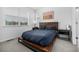 Modern bedroom featuring a platform bed with rustic wood accents and a view of the neighborhood at 1342 Independence St # 6, Lakewood, CO 80215