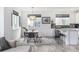 Bright dining area features pendant lighting, table with bench, and is adjacent to a modern kitchen with breakfast bar at 1342 Independence St # 6, Lakewood, CO 80215