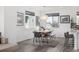 Bright dining area with modern light fixture, table with bench seating, area rug, and large windows with custom blinds at 1342 Independence St # 6, Lakewood, CO 80215