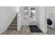 Bright entryway with wood floors, staircase, and glass front door at 1342 Independence St # 6, Lakewood, CO 80215