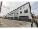 Townhome exteriors with gray garages and modern architectural elements at 1342 Independence St # 6, Lakewood, CO 80215