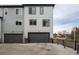 The townhome's exterior features a gray garage and modern architectural elements at 1342 Independence St # 6, Lakewood, CO 80215