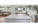 Kitchen island with quartz countertop overlooks the dining area and living room for easy entertaining in this open floor plan at 1342 Independence St # 6, Lakewood, CO 80215