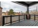 A covered porch has brick pillars and overlooks the neighborhood streets at 1342 Independence St # 6, Lakewood, CO 80215