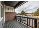 A covered porch overlooks neighborhood with black railings and brick pillars at 1342 Independence St # 6, Lakewood, CO 80215