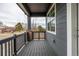 A covered porch with black railings and brick pillars overlooks the street at 1342 Independence St # 6, Lakewood, CO 80215