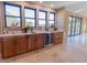 Stylish bar area featuring custom cabinets, wine fridge, and a beautiful view from the multiple windows at 20101 Spring Gulch Rd, Morrison, CO 80465