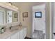 Bright bathroom features a modern vanity, light fixtures, and a view into the adjacent shower area at 20101 Spring Gulch Rd, Morrison, CO 80465