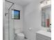 Modern bathroom with a sleek glass-enclosed shower, white vanity, and contemporary fixtures at 20101 Spring Gulch Rd, Morrison, CO 80465