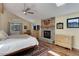 Inviting main bedroom with stone fireplace, ceiling fan, skylight and a large window with wooded view at 20101 Spring Gulch Rd, Morrison, CO 80465