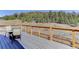 Outdoor deck with a natural wood railing and forest view at 20101 Spring Gulch Rd, Morrison, CO 80465