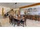 Large dining table with kitchen access, stairs and hallway at 20101 Spring Gulch Rd, Morrison, CO 80465