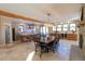 Open concept dining area with fireplace, wood beams, and kitchen access at 20101 Spring Gulch Rd, Morrison, CO 80465