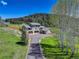 Stunning exterior of a modern home featuring a long driveway and meticulously landscaped yard at 20101 Spring Gulch Rd, Morrison, CO 80465