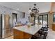 Bright kitchen with large island, bar seating, and stainless steel appliances, seamlessly connects to the outdoors at 20101 Spring Gulch Rd, Morrison, CO 80465