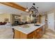 Open concept kitchen featuring a modern island with barstools, leading to a dining area and staircase at 20101 Spring Gulch Rd, Morrison, CO 80465