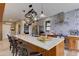 Kitchen island with seating, overhead pot rack, and tile backsplash at 20101 Spring Gulch Rd, Morrison, CO 80465