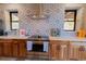 Kitchen with stainless steel oven, custom cabinetry and tile backsplash at 20101 Spring Gulch Rd, Morrison, CO 80465
